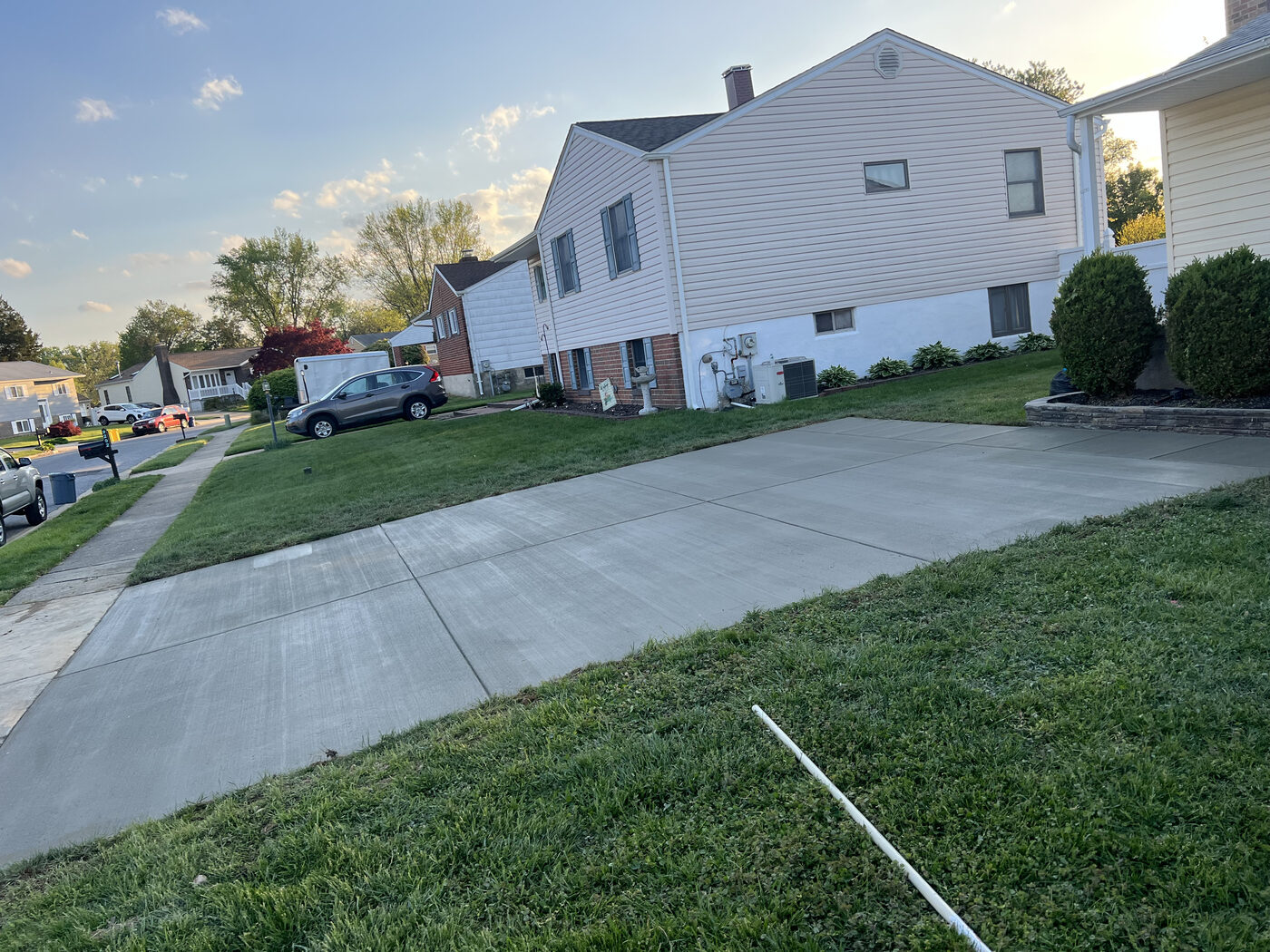 Clean concrete driveway pad beside a townhome
