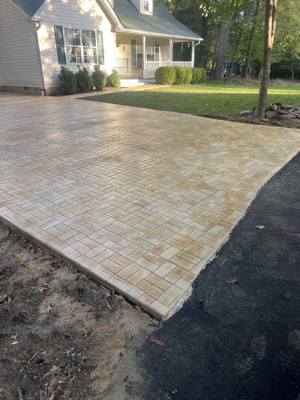 Stamped herringbone brick-pattern concrete driveway