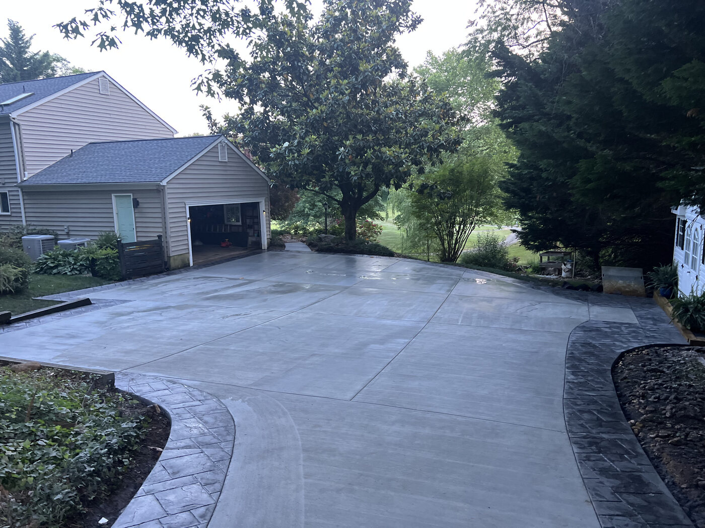 Wide concrete driveway with a stamped decorative border
