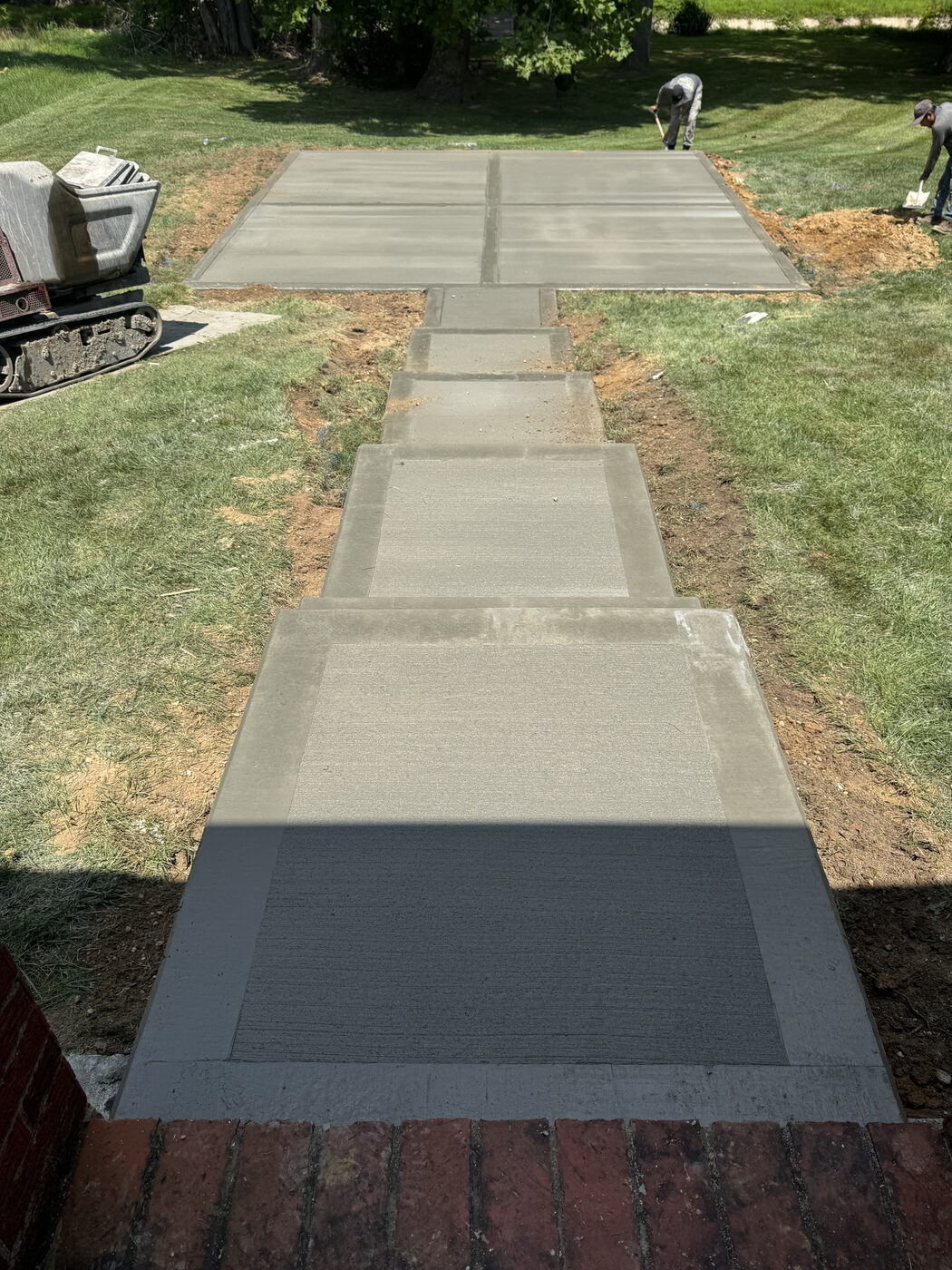 Concrete walkway with stepping pad sections leading to a patio