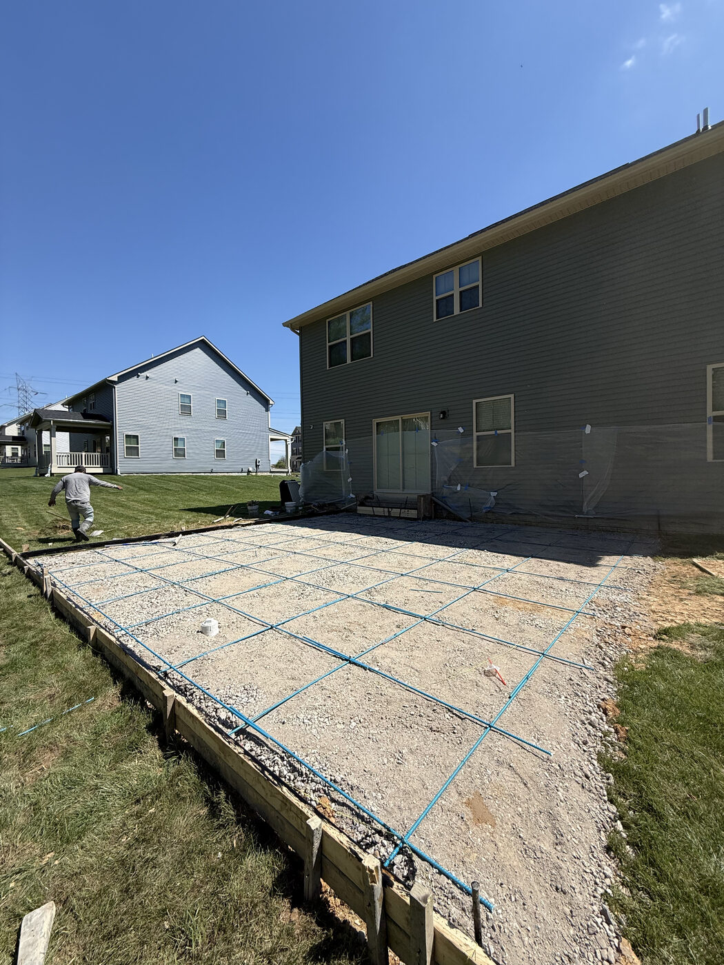 Rebar grid and wood forms set in a backyard before a pour
